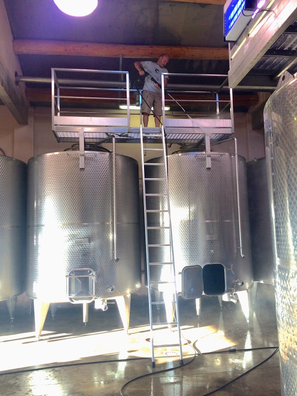 John cleaning the ceiling and tops of the tanks